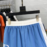 Flat lay presentation of Rhude luxury clothing with runway-inspired design