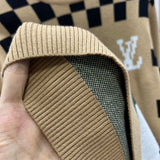 Side profile of Louis Vuitton luxury clothing with logo-detail design