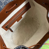 Side profile of elevated polished women's handbag – women's luxury accessory