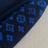 Flat lay presentation of Louis Vuitton luxury clothing with contemporary cut
