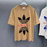 Flat lay presentation of Gucci luxury clothing with monogram-inspired silhouette