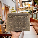 Side view of streamlined structured handbag