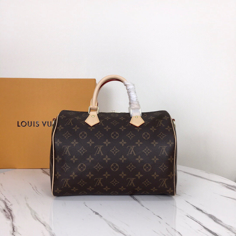 Side profile of signature statement women's handbag – women's luxury accessory