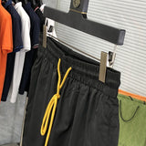 Flat lay presentation of Rhude luxury clothing with label-forward styling