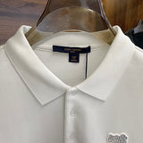 Close-up detail shot of Louis Vuitton luxury clothing with label-forward styling