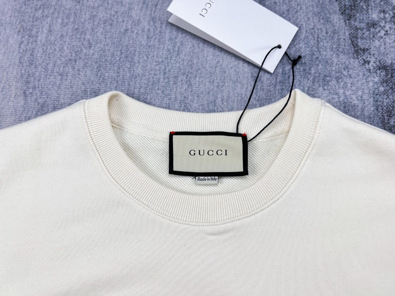 Close-up detail shot of Gucci luxury clothing with signature branding