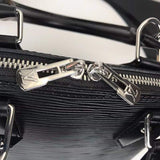 Styled lifestyle shot of classic signature women's handbag – women's luxury handbag
