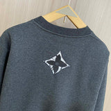 Flat lay presentation of Louis Vuitton luxury clothing with label-forward styling