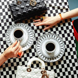 Side profile of elevated modern women's handbag – women's luxury accessory