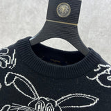 Close-up detail shot of Louis Vuitton luxury clothing with label-forward styling