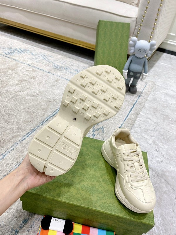 Side profile of Gucci neutral cream sneakers signature lace-up style