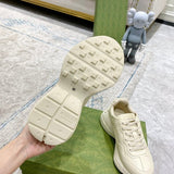 Side profile of Gucci neutral cream sneakers signature lace-up style