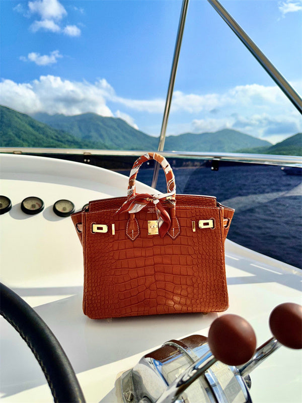  Signature top-handle bag carried on shoulder 10