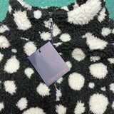 Close-up detail shot of Louis Vuitton luxury clothing with logo-detail design
