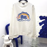 Close-up detail shot of Louis Vuitton luxury clothing with label-forward styling