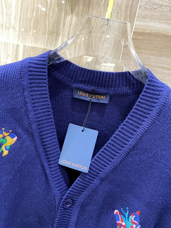 Flat lay presentation of Louis Vuitton luxury clothing with signature branding