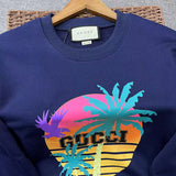 Flat lay presentation of Gucci luxury clothing with signature branding