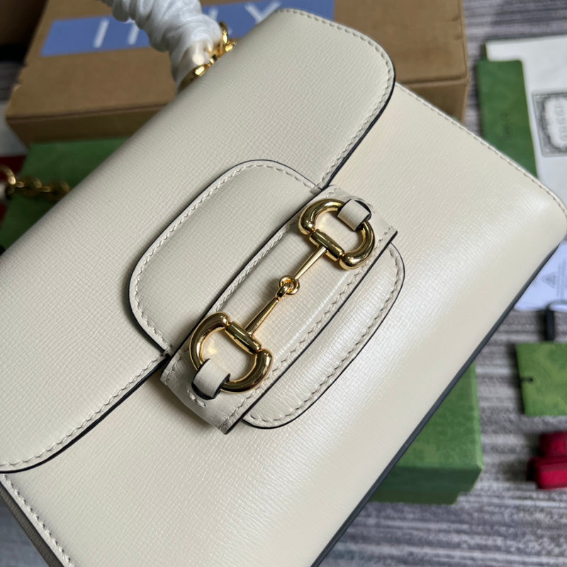 Styled lifestyle shot of signature sleek women's handbag – women's luxury accessory