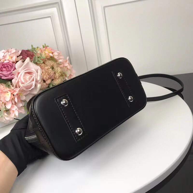 Handle and strap detail of classic signature women's handbag – women's luxury handbag