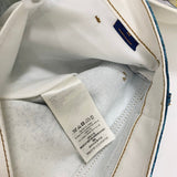 Close-up detail shot of Louis Vuitton luxury clothing with signature branding
