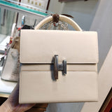 Side view of tailored structured handbag