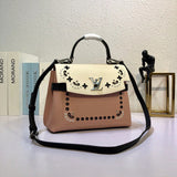Side profile of structured signature women's handbag – women's statement bag