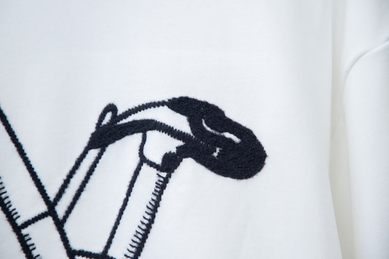 Flat lay presentation of Louis Vuitton luxury clothing with logo-detail design
