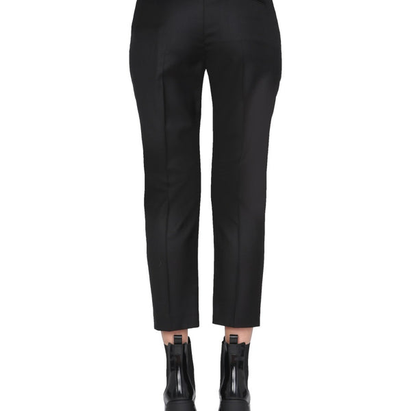 Close-up of Alexander McQueen pants hardware and fine stitching