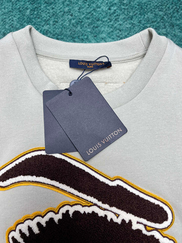 Close-up detail shot of Louis Vuitton luxury clothing with monogram-inspired silhouette