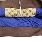Side profile of Gucci luxury clothing with label-forward styling