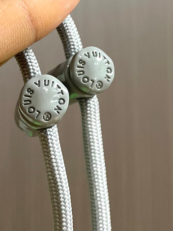 Close-up detail shot of Louis Vuitton luxury clothing with logo-detail design