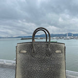 Side view of poised structured handbag