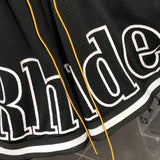 Flat lay presentation of Rhude luxury clothing with everyday silhouette