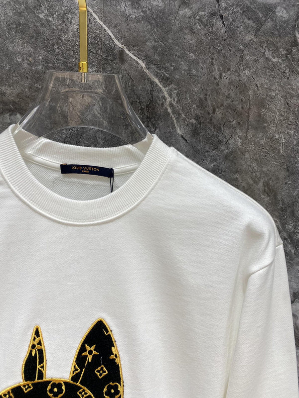 Close-up detail shot of Louis Vuitton luxury clothing with label-forward styling