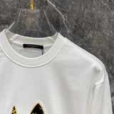 Close-up detail shot of Louis Vuitton luxury clothing with label-forward styling