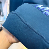 Close-up detail shot of Louis Vuitton luxury clothing with everyday silhouette