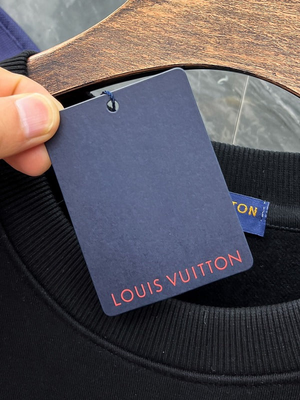 Close-up detail shot of Louis Vuitton luxury clothing with signature branding