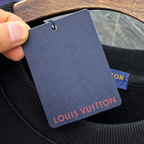 Close-up detail shot of Louis Vuitton luxury clothing with signature branding