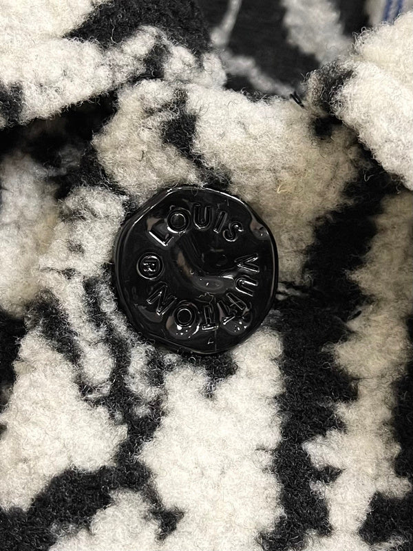 Flat lay presentation of Louis Vuitton luxury clothing with logo-detail design