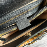 Front view of classic signature women's handbag – women's luxury accessory
