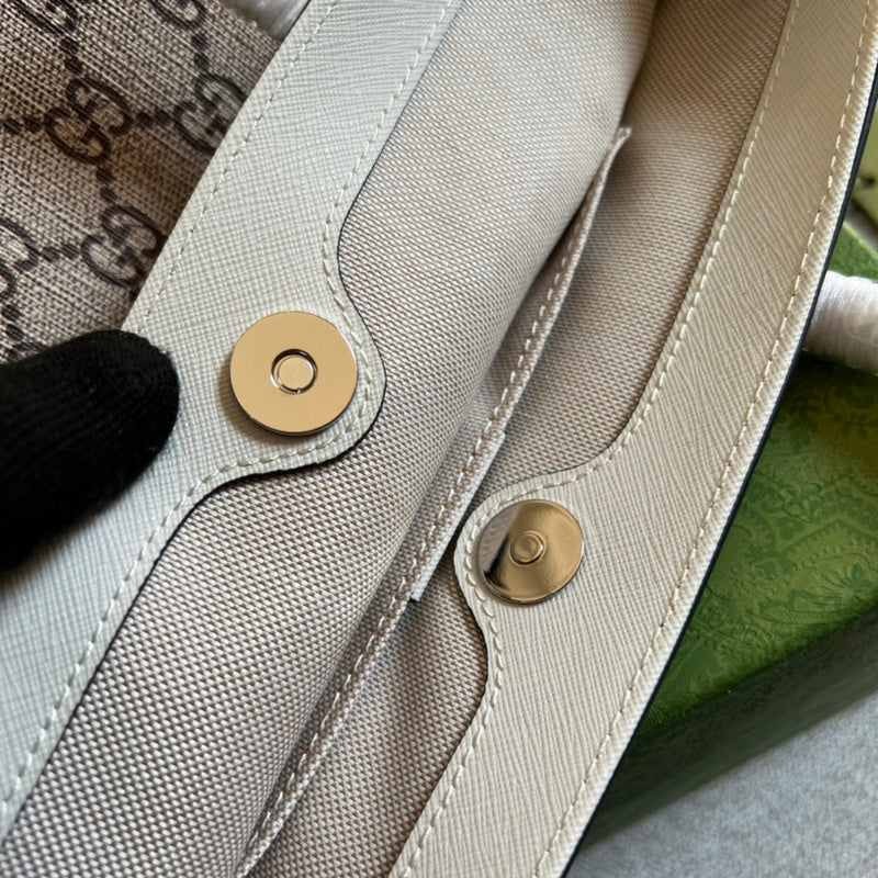 Side profile of sleek signature women's handbag – women's luxury handbag