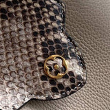 Handle and strap detail of modern refined women's handbag – women's designer-style accessory