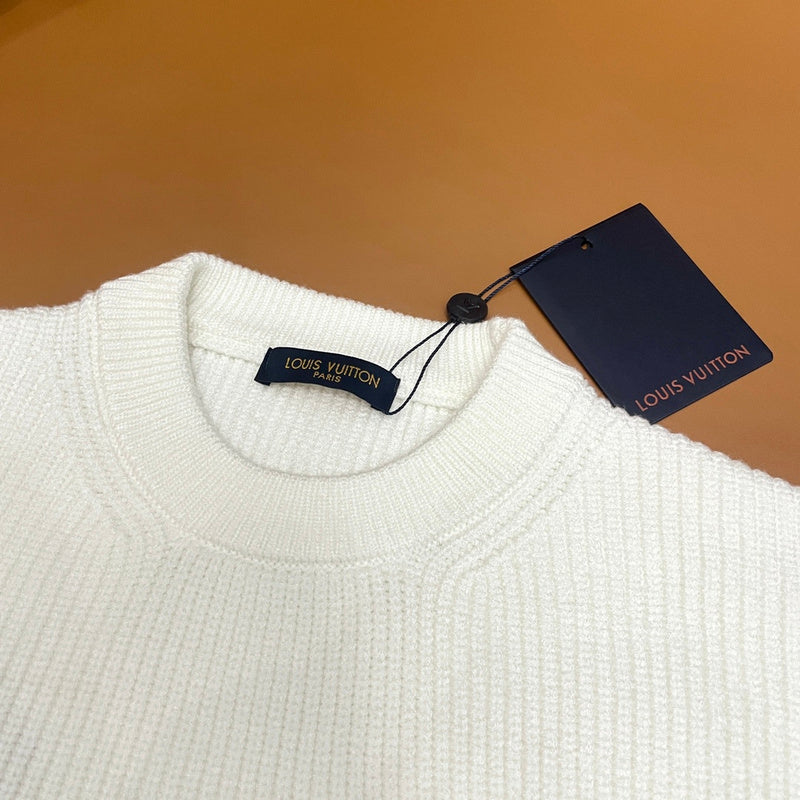 Close-up detail shot of Louis Vuitton luxury clothing with monogram-inspired silhouette