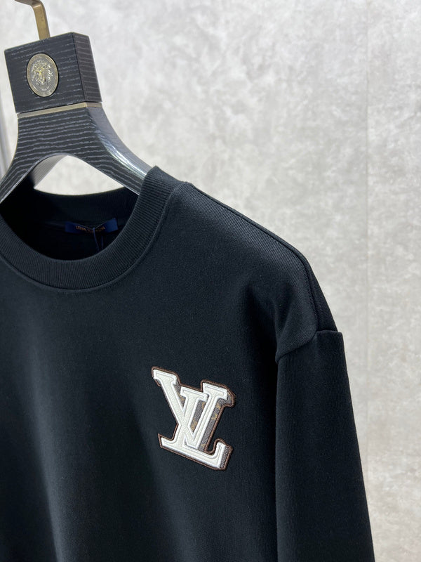 Flat lay presentation of Louis Vuitton luxury clothing with logo-detail design
