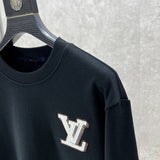 Flat lay presentation of Louis Vuitton luxury clothing with logo-detail design