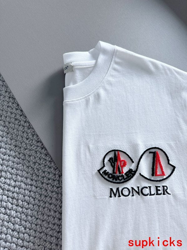 Flat lay presentation of Moncler luxury clothing with tailored silhouette
