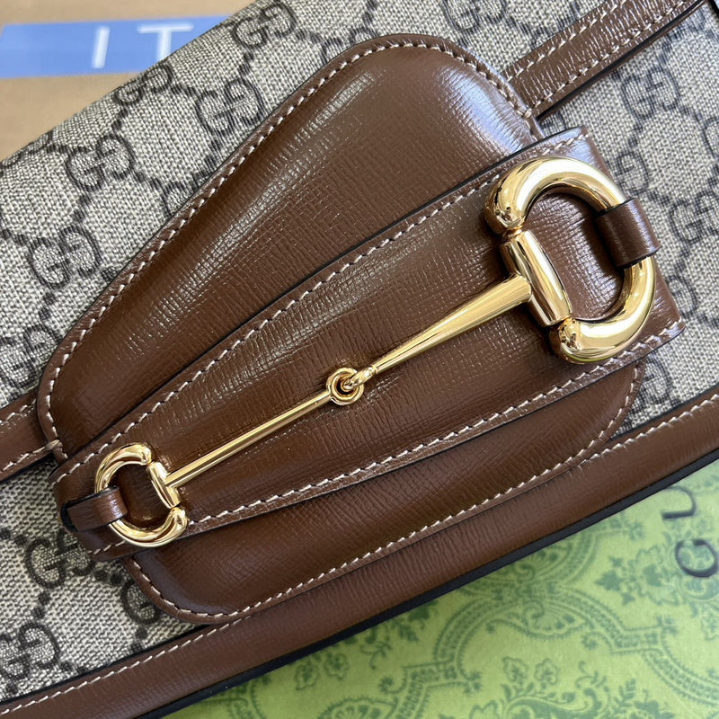 Handle and strap detail of structured polished women's handbag – women's designer-style accessory