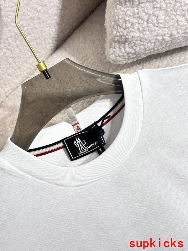 Close-up detail shot of Moncler luxury clothing with signature branding