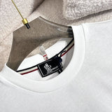 Close-up detail shot of Moncler luxury clothing with signature branding