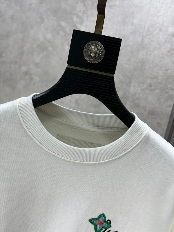 Close-up detail shot of Louis Vuitton luxury clothing with logo-detail design